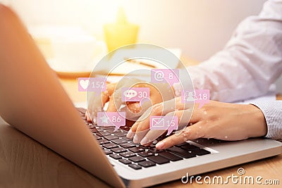 People using notebook computer laptop for social media interactions with notification icons from friend in social network Stock Photo