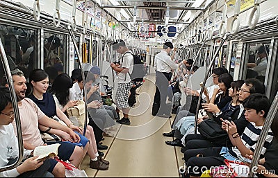 People using smart phones inside subway wagon while riding. Concept of lack of communication in modern Editorial Stock Photo