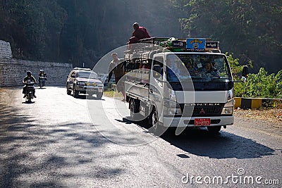 People and vehicles on mountain road in Inle, Myanmar Editorial Stock Photo