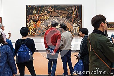 People view painting in room of Uffizi Gallery Editorial Stock Photo