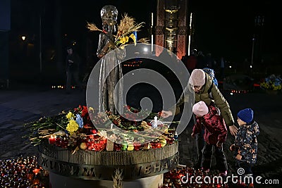 People visit a monument to Holodomor big hunger victims during a commemoration ceremony in Kyiv, Ukraine Editorial Stock Photo