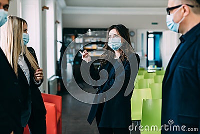 People vs covid. Young business company manager and team of responsible employees care about clients and coworkers wearing Stock Photo