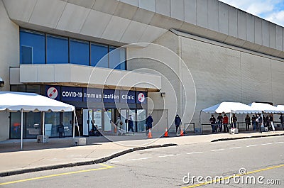 People wait in line for a Covid-19 vaccine at the City of Toronto Vaccination Clinic at Scarborough Town Centre Editorial Stock Photo