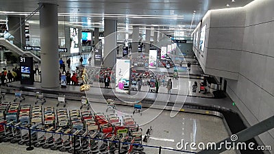 People waiting in Baggage claim area of Shanghai Hongqiao Airport Editorial Stock Photo