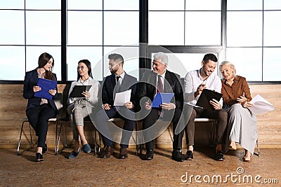 People waiting for job interview in hall Stock Photo