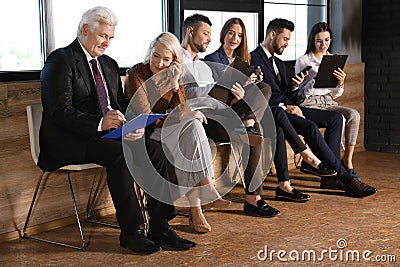 People waiting for job interview in hall Stock Photo