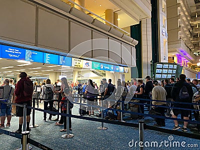 People waiting in line to go through Orlando International Airport MCO TSA security Editorial Stock Photo