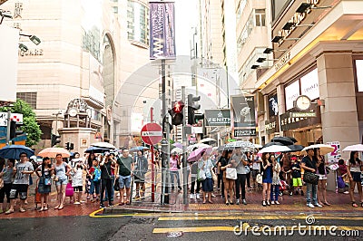 People waiting to cross through busy streets at Hong Kong Times Editorial Stock Photo