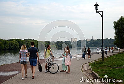 People walk along the embankment in the Moscow estate Kolomenskoye Editorial Stock Photo