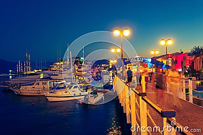 People walk along pedestrian bridge on yacht marina of Marmaris old town Editorial Stock Photo
