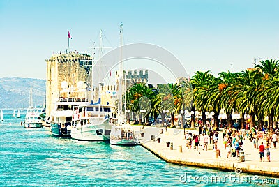 People walk along the picturesque pier of Trogir Editorial Stock Photo