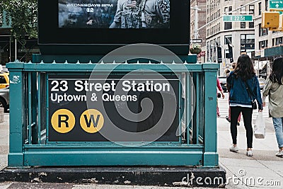 People walk by the entrance to 23 Street subway station in New York, USA. Editorial Stock Photo