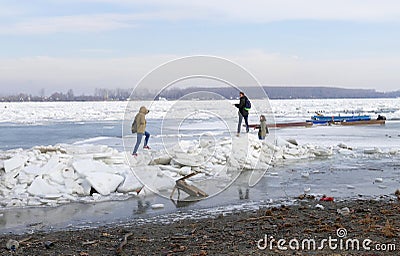 People walk on the frozen Danube river Editorial Stock Photo