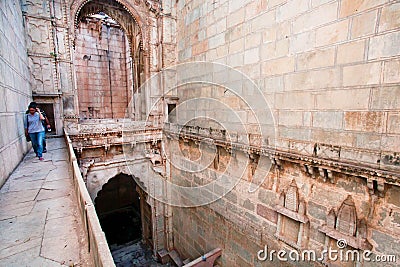 People walk inside the Queen's stepwell Editorial Stock Photo