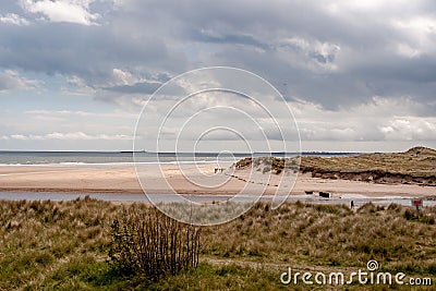 People walking on Alnmouth Beac Stock Photo