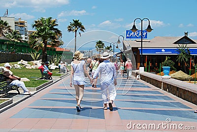 People walking along Benalmadena promenade. Editorial Stock Photo