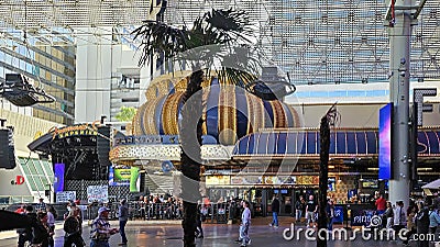 People walking along the street at the Fremont Street Experience with restaurants and retail stores and a video screen ceiling Editorial Stock Photo