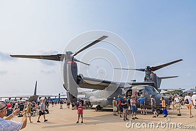 People walking around a Boeing CV-22 Osprey at EAA AirVenture 2021. Editorial Stock Photo