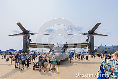 People walking around a Boeing CV-22 Osprey at EAA AirVenture 2021. Editorial Stock Photo