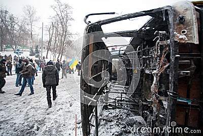 People walking around burned street with broken mi Editorial Stock Photo