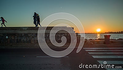 People walking through the burriana breakwater Editorial Stock Photo