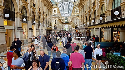 People walking in famous Italian shopping center with luxury boutiques, tourism Editorial Stock Photo