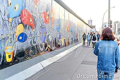 People walking and looking at Art gallery of Graffiti on Berlin Wall at East side Editorial Stock Photo