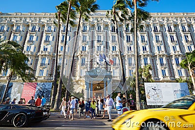 People walking and luxury cars passing in Cannes Editorial Stock Photo