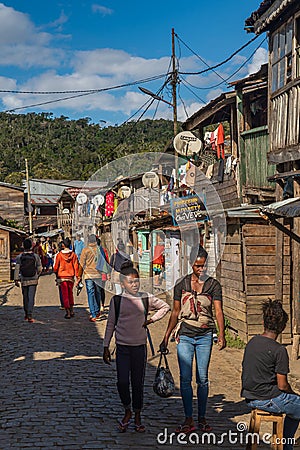 People walking at the main road at the village Andasibe, lined with shops Editorial Stock Photo