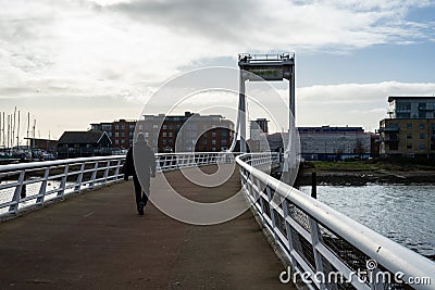 People walking over Forton Lake Bridge or the Millennium Bridge in Gosport UK Editorial Stock Photo