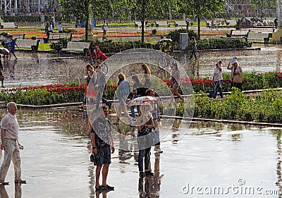 People walking in the Park during an unexpected spring rain Editorial Stock Photo