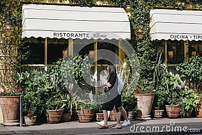People walking past Gloria, Italian restaurant in Shoreditch, London, UK Editorial Stock Photo