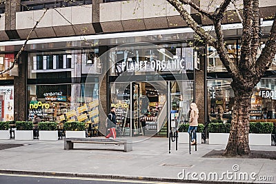 People walking past Planet Organic food store in Tottenham Court Road, London, UK Editorial Stock Photo