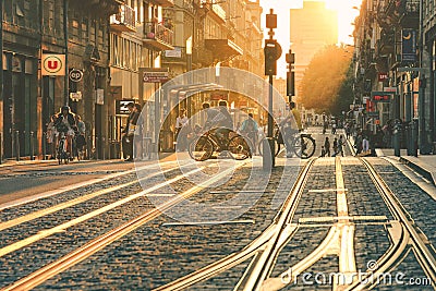 People walking on street with tramway during the sunset in Bordeaux Editorial Stock Photo