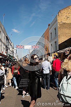 People walking on the street, visiting Portobello road market in Notting Hill, London Editorial Stock Photo
