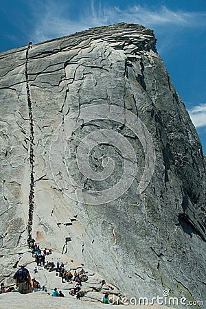 People walking up Half Dome Stock Photo