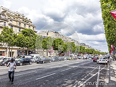 People walking and visiting the famous street in Paris, the Champs dÂ´elysees in the heart of Paris Editorial Stock Photo