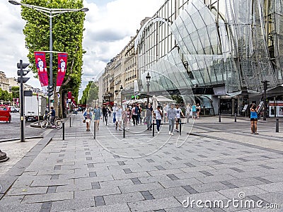 People walking and visiting the famous street in Paris, the Champs dÂ´elysees in the heart of Paris Editorial Stock Photo