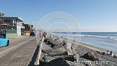 People walking, waterfront promenade beachfront boardwalk. Ocean beach near Los Angeles, California USA Editorial Stock Photo