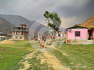 People walks on trodden paths on the grass in the village Manthali in Ramechhap District in Nepal Editorial Stock Photo