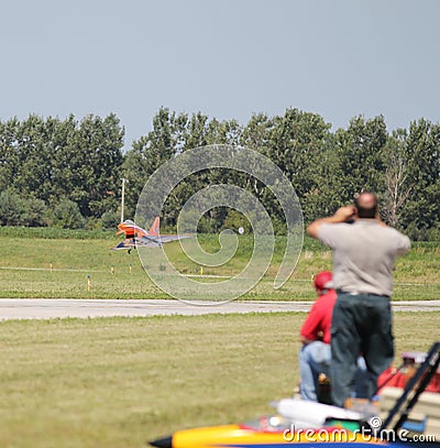 People watch Model Airplane Land Editorial Stock Photo