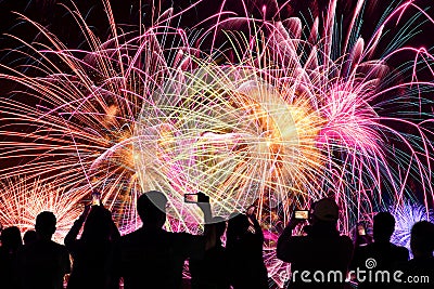 People Watching Fireworks Display Stock Photo