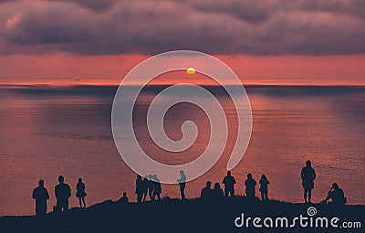 People watching the sunset on sea Stock Photo