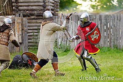 People wearing knight costumes during historical reenactment on annual Medieval Festival, held in Trakai Peninsular Castle Editorial Stock Photo