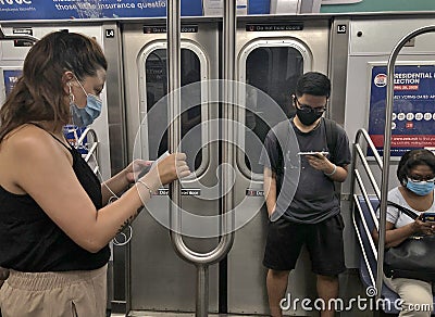 People Wearing Protective Face Mask Riding the MTA Subway Public Transit Editorial Stock Photo