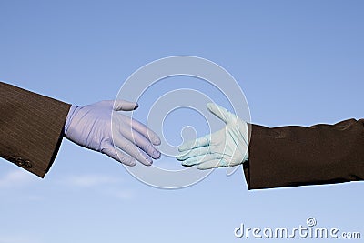 people wearing protective gloves reaching out for handshake Stock Photo