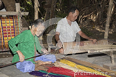 People weaving sedge grass mats. Editorial Stock Photo