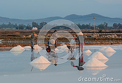 People work on salt fields in Hon Khoi, Khanh Hoa, Vietnam Editorial Stock Photo