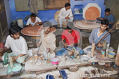 People work in a workshop creating traditional floral marble design, produced by muslim Bharai community in Agra, India. Editorial Stock Photo