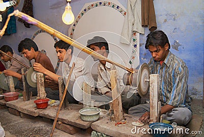 People work in a workshop creating traditional floral marble design, produced by muslim Bharai community in Agra, India. Editorial Stock Photo